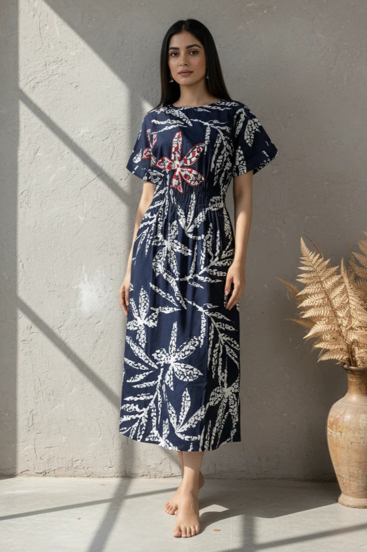 Orange Floral Print Midi Dress featuring embroidered bodice highlights and relaxed silhouette.